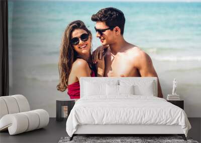 Vacation romantic lovers young happy couple hug and standing on sand at sea having fun and relaxing together on tropical beach.Summer vacations Wall mural