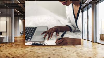 Young african american black woman relaxing and using laptop computer with white mockup blank screens.woman checking social apps and working.Communication and technology concept Wall mural