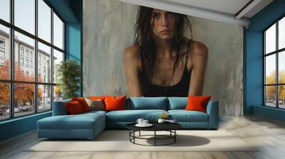 Contemplative young woman with wet hair in casual attire against a textured backdrop Wall mural