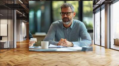 Group of three business people engaged in a productive meeting discussing strategy and planning in a modern office setting Wall mural