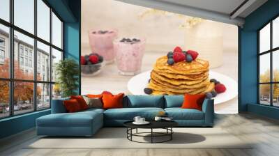 Pancakes with blueberries, 
raspberries and tasty 
berry smoothies for breakfast. Plate of homemade pancakes with forest berries on wooden table    Wall mural