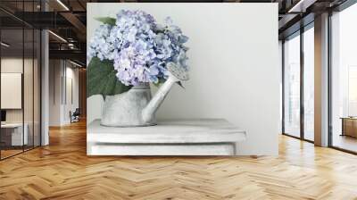 Hydrangea flowers in grunge zinc watering can on vintage wooden Wall mural