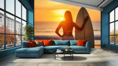 Photo surfer watching the sea holding surfboard in silhouette style. sunset and sunrise of the sea beach photography Wall mural