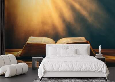 An open book illuminated by soft light, symbolizing knowledge and spirituality. Wall mural