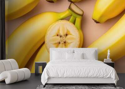 A vibrant collection of fresh yellow bananas is artistically arranged on a light surface Wall mural