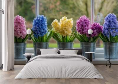 Colorful flower pots lined up on a window sill in a bright and sunny indoor space Wall mural