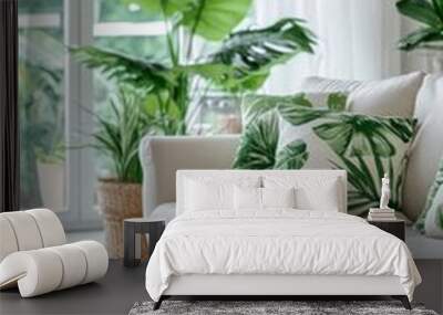 Cozy living room with tropical plants and leaf-patterned pillows in bright sunlight Wall mural