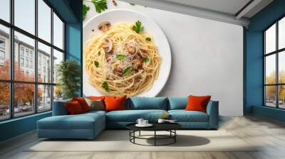 Delicious mushroom pasta topped with fresh basil on a white plate with garnishes Wall mural