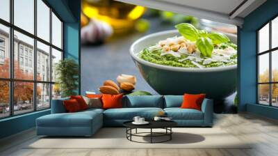 Fresh basil pesto with nuts and garlic served in a bowl on a dark countertop Wall mural