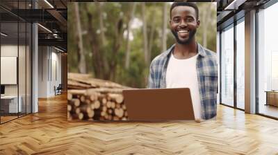 man holding laptop and smiling at camera man Wall mural