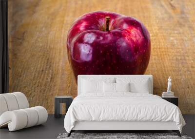 Single red ripe sweet apple with green leaves Wall mural