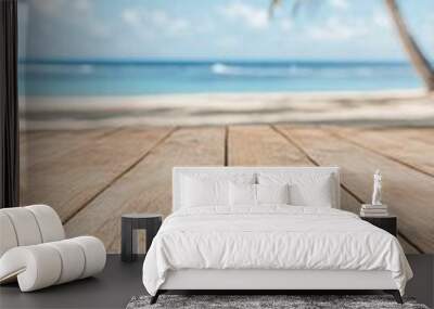 Tranquil beach view with wooden deck, palm trees, and serene ocean under clear blue sky Wall mural