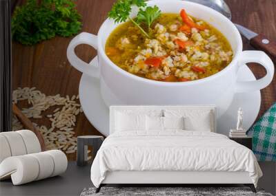 White bowl of chicken and wild rice soup with vegetables Wall mural