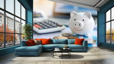 White Piggy Bank Surrounded by Coins and Financial Charts on a Desk Wall mural