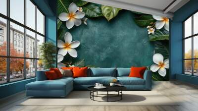 White plumeria flowers surrounded by green leaves on a textured blue surface in a natural setting Wall mural