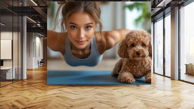 Woman exercising on a mat with a small fluffy dog beside her in a bright indoor space Wall mural