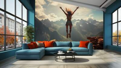 young woman jumping for joy on the mountains Wall mural