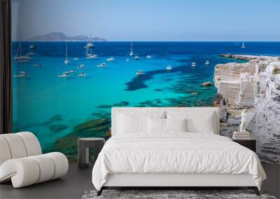 Beautifu panoramic view of rocky beach and blue lagoon with sailing boats. Favignana island Wall mural