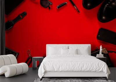 Black objects on a red background. Clothing, accessories and gadgets. The concept of a Black Friday sale. Wall mural