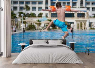 Boy in a swimming pool. Wall mural