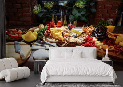 Dish of delicious snacks of cheese, prosciutto, fresh herbs, fruits and berries Wall mural