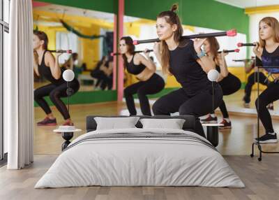 Fitness, sport, training and lifestyle concept - group of women with barbells in gym Wall mural