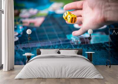 Hand throws two yellow dice on the blue playing field. Gaming moments in dynamics. Luck and excitement. Board games Wall mural