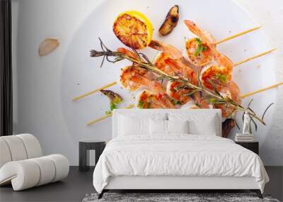 grilled shrimp on skewers. Grilled seafood on skewers with spices, herbs and lemon. delicious prawn. White plate. White background Wall mural