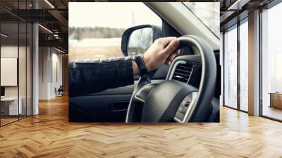 Man driving car on countryside. Inside view. Wall mural