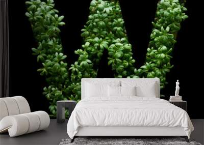 Capital letter W is created from young green arugula sprouts on a black background. Wall mural