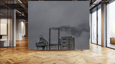 old plant polluting atmosphere with two chimneys. Wall mural