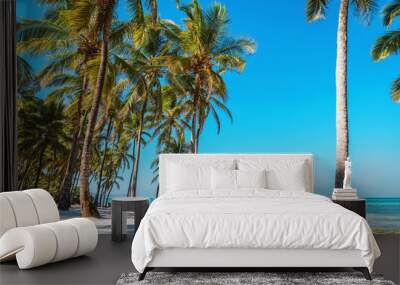 Kissing couple on tropical beach with palm trees Wall mural