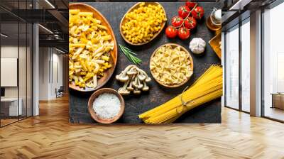 Assortment of different types of raw pasta with mushrooms, tomatoes and garlic. Wall mural