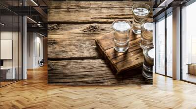 glasses with vodka on the old board. Wall mural