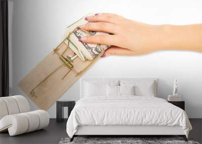 Hand with money in a mousetrap. On a white background. Wall mural