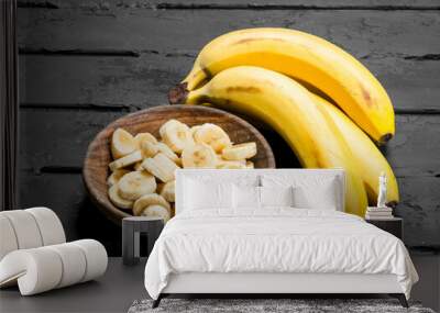 Juicy fresh bananas and banana slices in a plate. Wall mural