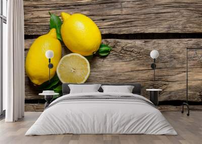 Lemons with leaves. On wooden background. Wall mural