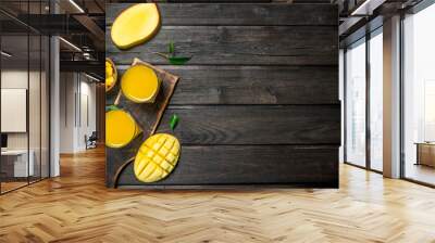 Mango juice in a glass on a cutting Board. Wall mural