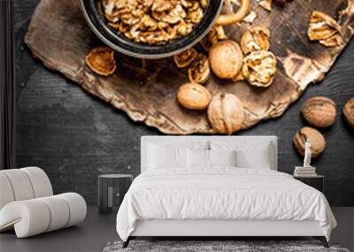 Shelled walnuts in bowl with Nutcracker. Wall mural