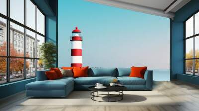 Solitary red and white lighthouse overlooking calm blue ocean under clear sky Wall mural