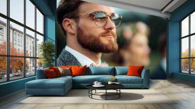 Stylish groom with glasses at outdoor wedding ceremony Wall mural