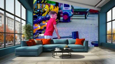 Technology, gaming, entertainment and people concept. Boy playing automatic toy hummer on playground at shopping mall. Wall mural