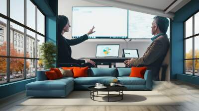 The business woman and a man discussing at the table in a modern office Wall mural