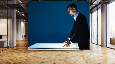 The businessman working with a sensor screen in the dark room Wall mural