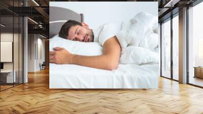 The man sleeping on the bed on the white background Wall mural