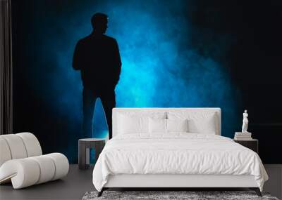 The man standing in the blue fog. evening night time Wall mural