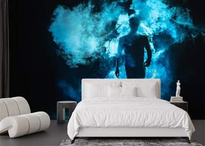 The man walking in the blue smoke on the dark background Wall mural