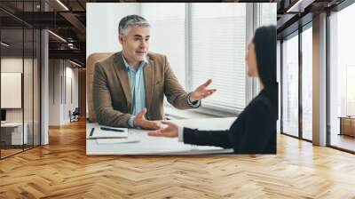 The two business people talking at the office table Wall mural