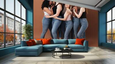 Group of cheerful women of different body type and ages standing together in a studio Wall mural