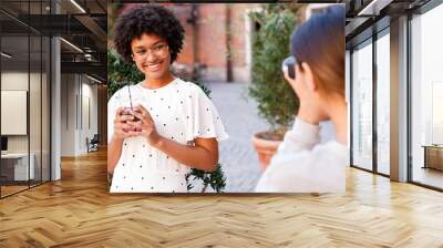 Photographer collaborating with a blogger. Two women creating content for social media. Wall mural